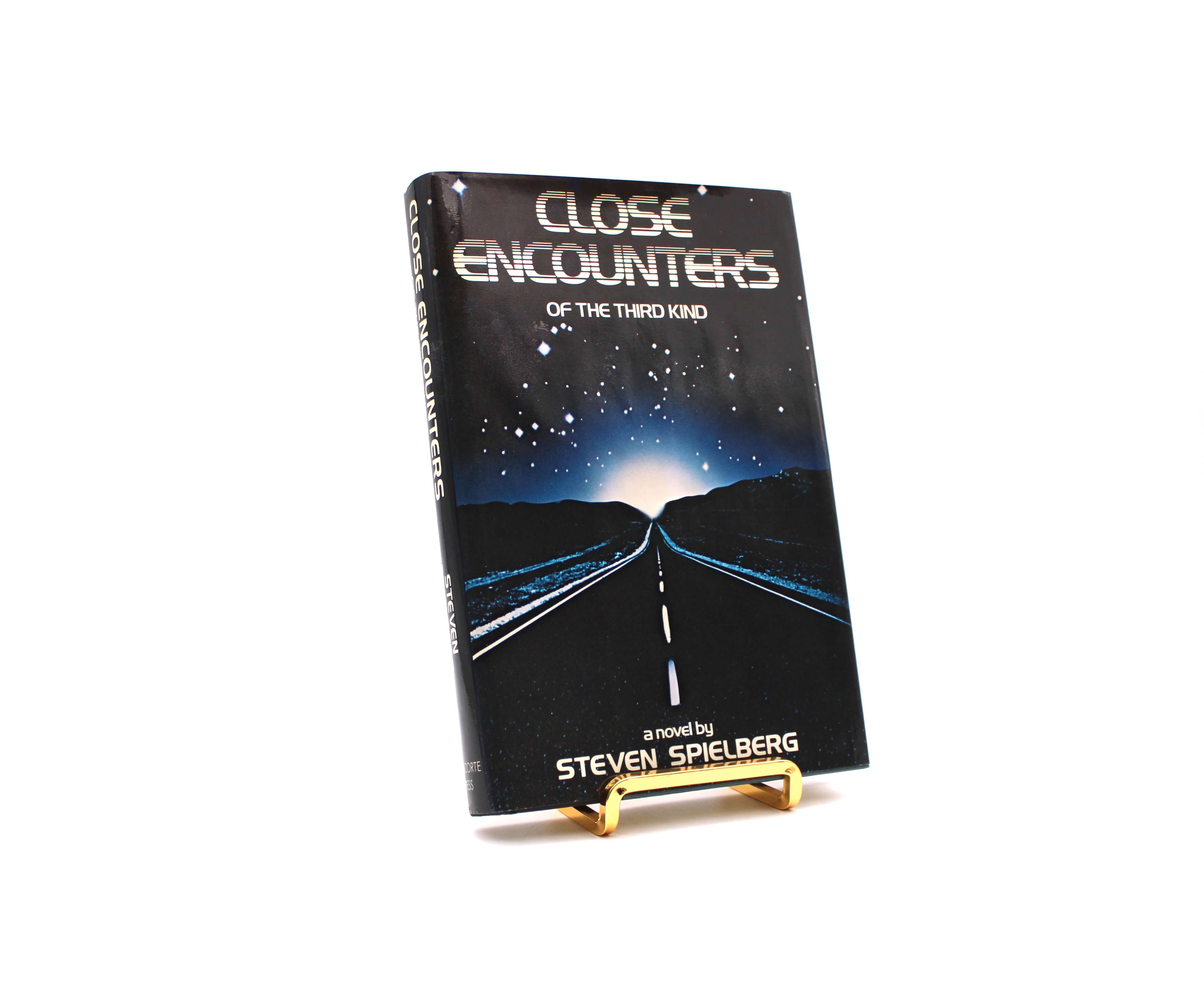 Close Encounters of the Third Kind. By Steven Spielberg. First Edition, First Printing. Delacorte. New York, 1977.